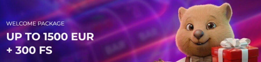 An online casino promotional welcome bonus banner featuring a 3D animated quokka mascot in a bow tie holding a wrapped red gift box with a white ribbon on the right. Set against a vibrant purple slot machine background, white bold text on the left reads "WELCOME PACKAGE UP TO 1500 EUR + 300 FS".