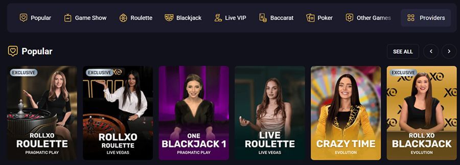 An online live casino lobby interface screenshot for RollXO Casino set on a dark theme displaying a top sub-navigation menu and a "Popular" game row. The top filter bar includes options for Popular, Game Show, Roulette, Blackjack, Live VIP, Baccarat, Poker, and Other Games alongside a Providers button. Below, six live dealer game cards display real human hosts: Pragmatic Play's RollXO Roulette with an "EXCLUSIVE" badge; Live Vegas's RollXO Roulette tagged "EXCLUSIVE XO"; Pragmatic Play's One Blackjack 1; Live Vegas's Live Roulette; Evolution's flagship game show Crazy Time featuring a presenter in front of a prize wheel; and Evolution's Roll XO Blackjack tagged "EXCLUSIVE XO".
